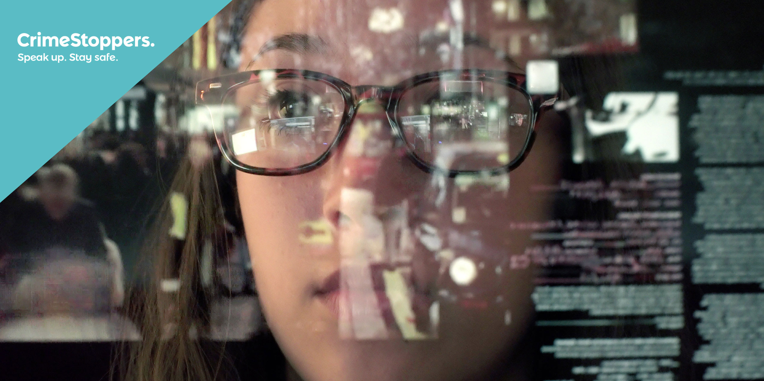 Woman with computer data reflected in her glasses