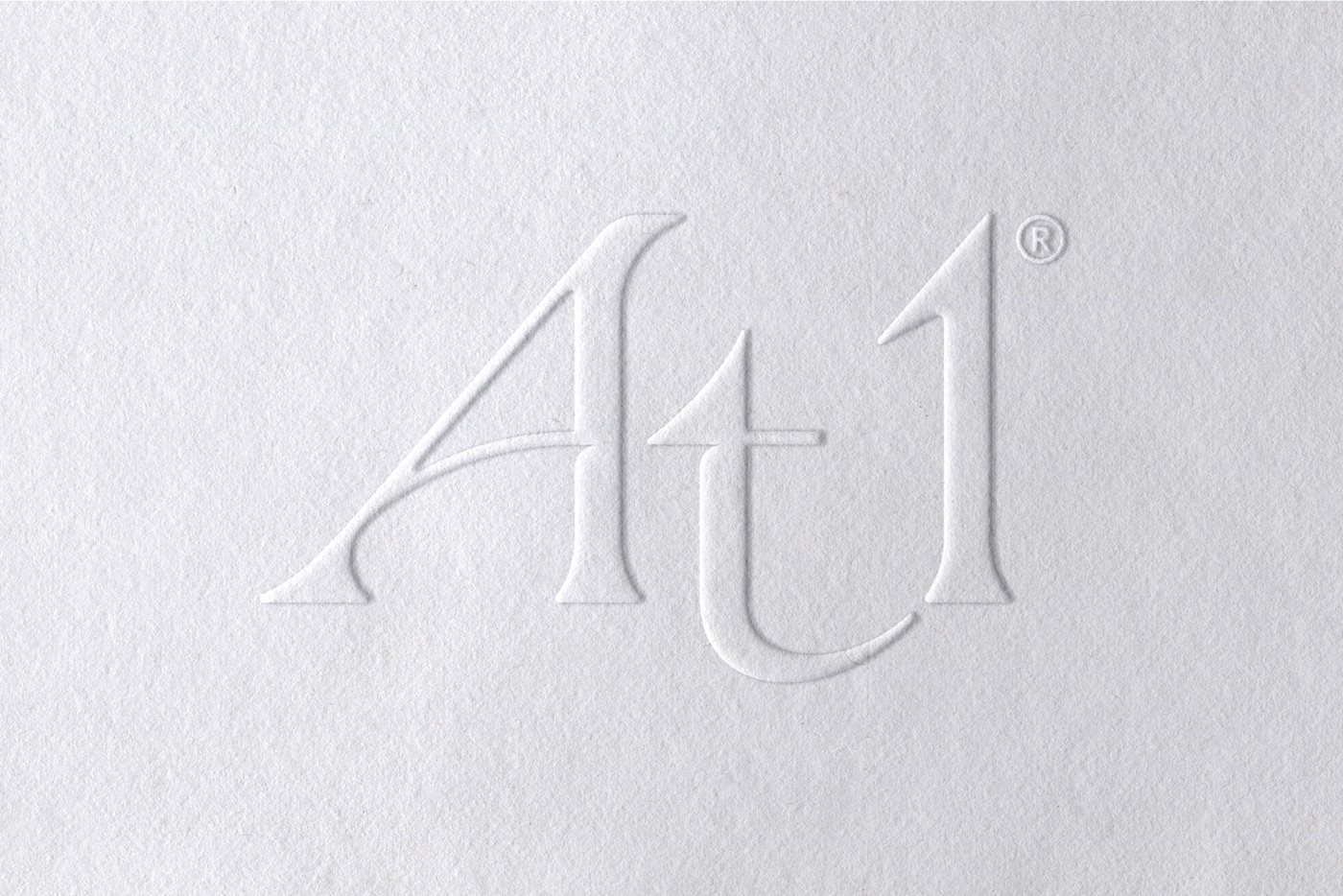 At1 logo embossed in to a white background