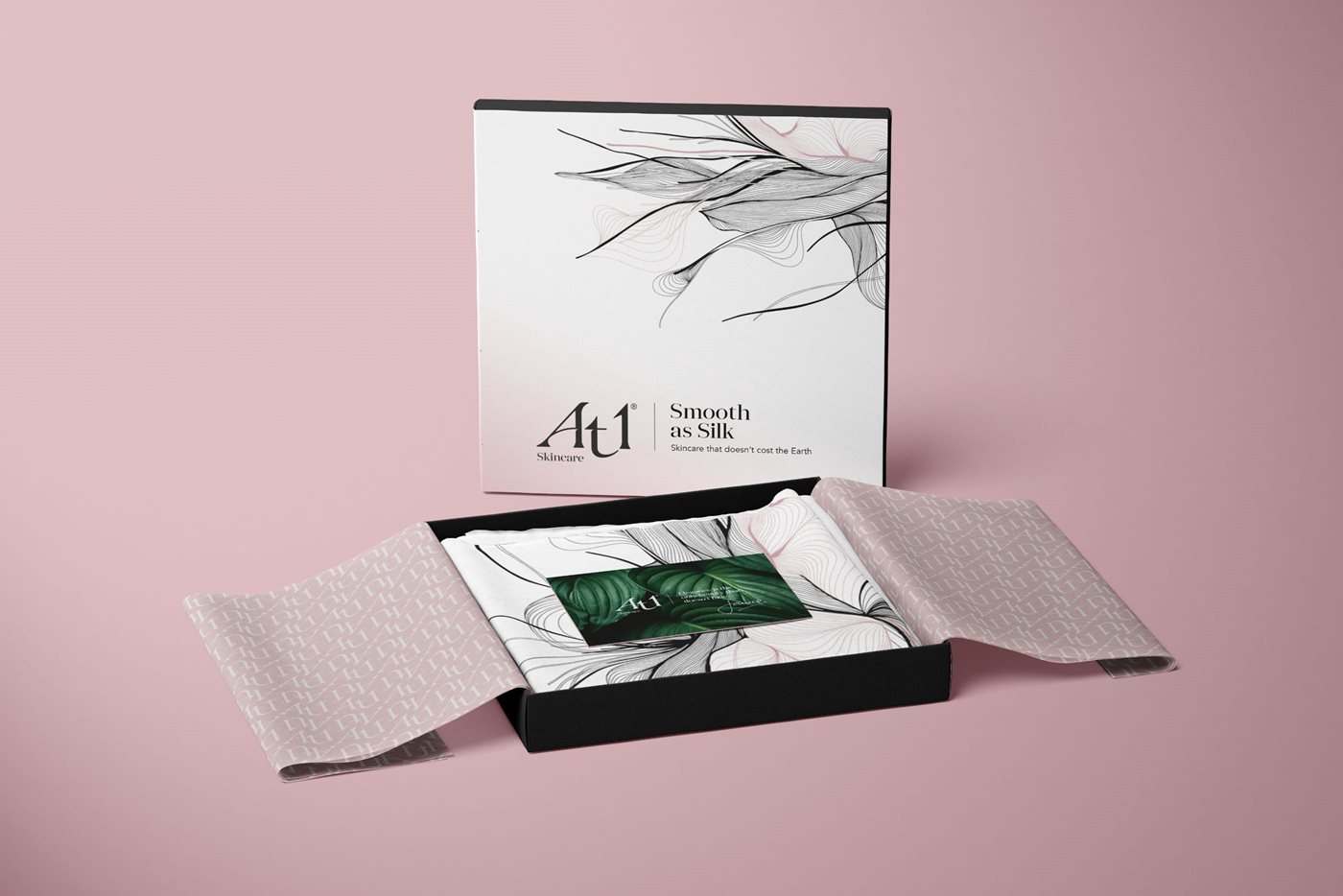 An open box showing a detailed scarf and business card