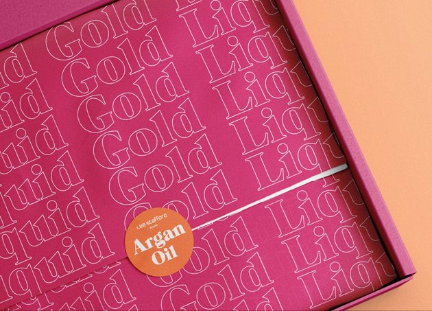 Argan Oil packaging with liquid gold text in a repeated pattern